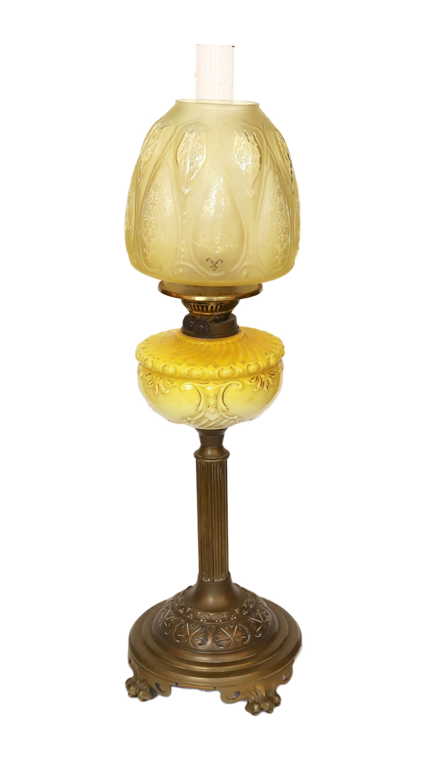 A Victorian brass oil lamp with opaque yellow glass reservoir, duplex mechanism, etched glass globe and flue, height overall 72cm